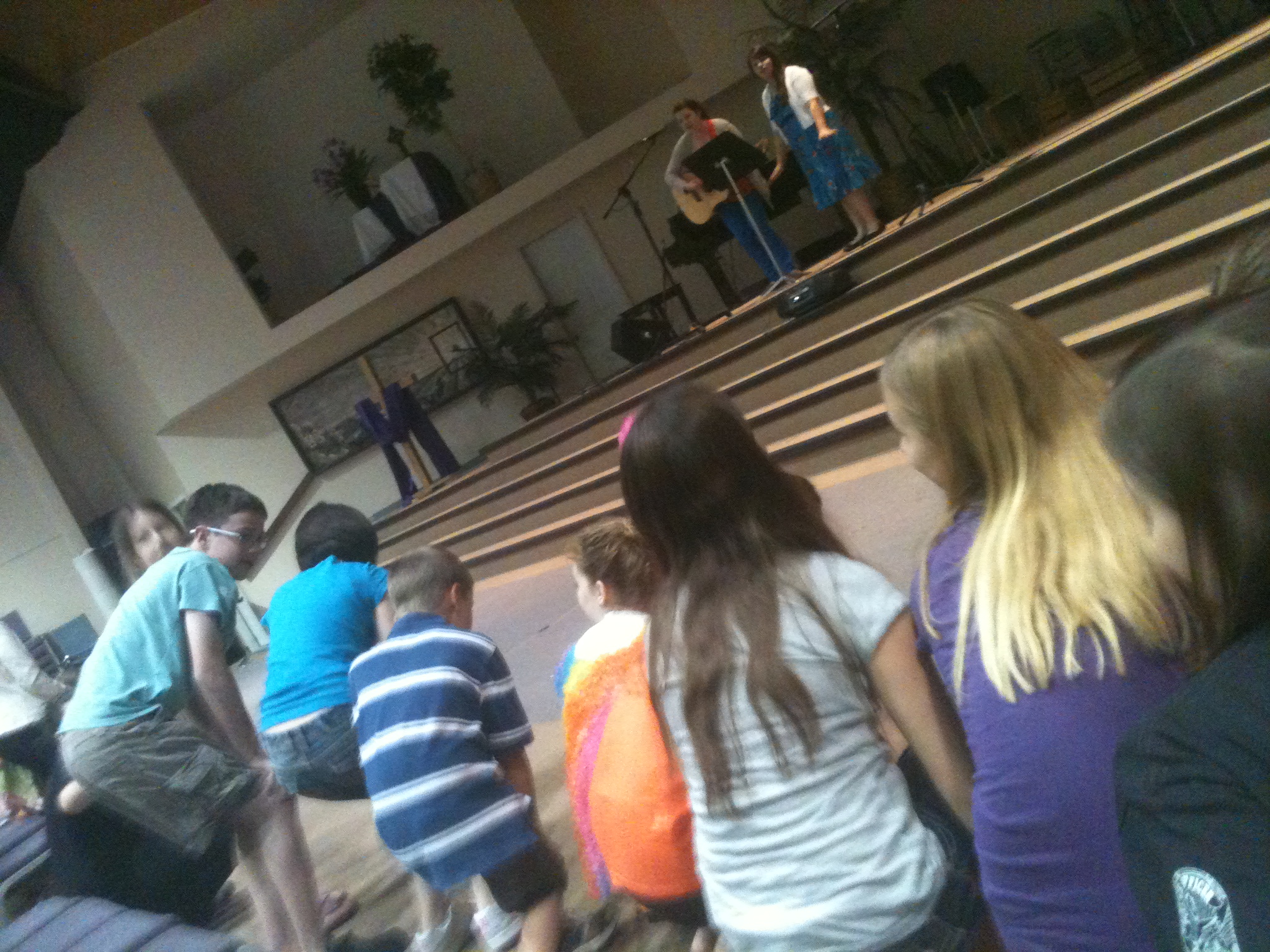 Children dancing and engaging with musicians at a church event